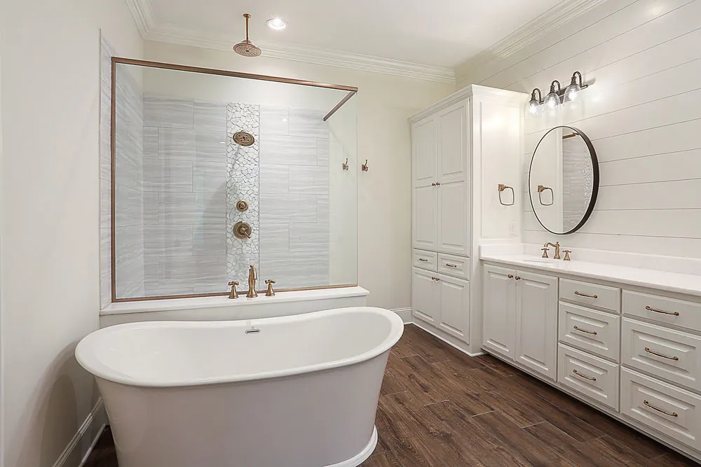 Primary bathroom with a freestanding tub, a large tiled shower and a long vanity